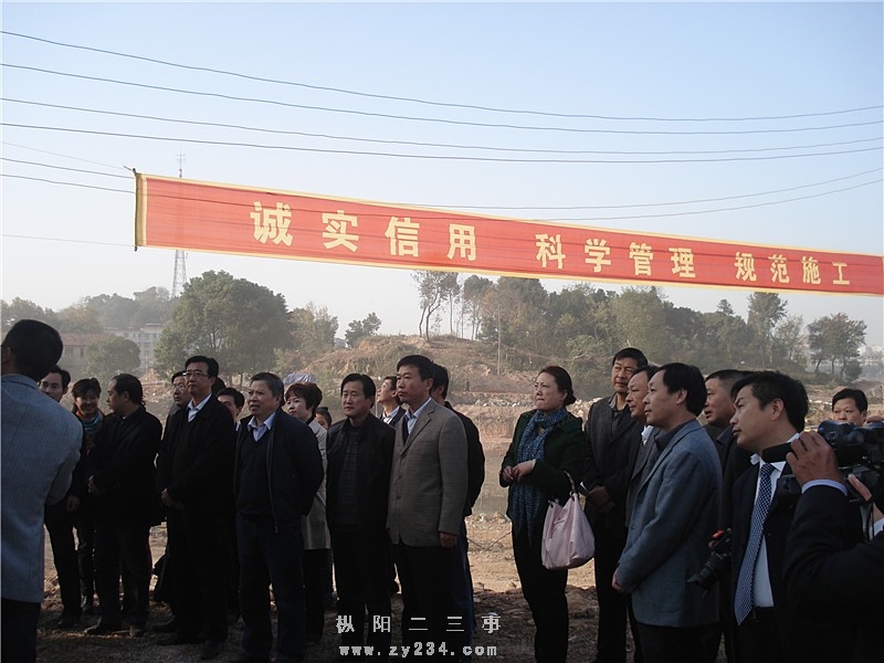 各媒体记者和网友代表在听相关人员对县城莲花湖公园建设情况讲解